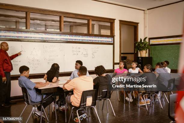 teacher leads pupils through math class - junior high stock pictures, royalty-free photos & images