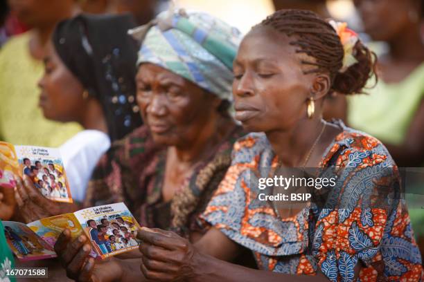 An African woman, Photo essay in Lome in Togo, West Africa. Meeting of information of the association Chain of hope on children sponsoring. Thanks to...