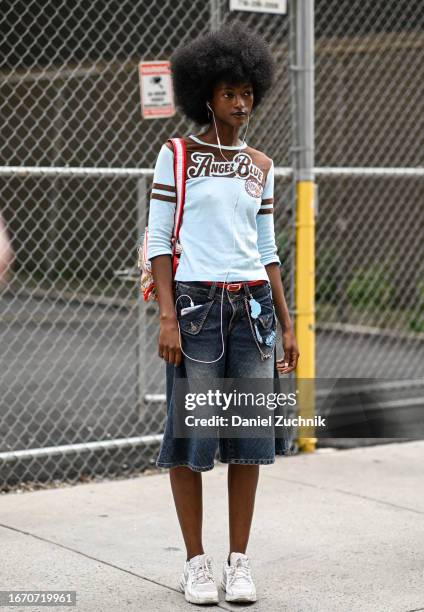 Model is seen wearing a light blue and brown shirt, jean shorts and white sneakers outside the Tibi show during NYFW S/S 2024 on September 09, 2023...