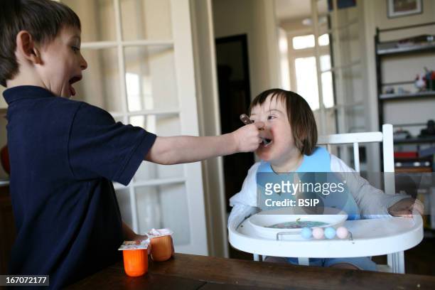 Child, down's syndrome, 18 month old girl with Down's syndrome with her older brother. Photo by: BSIP / Universal Images Group via Getty Images