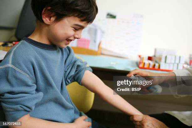 Tuberculin skin test, Photo essay in a vaccination center. Seance of vaccination. The doctor is practicing the TuberTest. This test permits to screen...