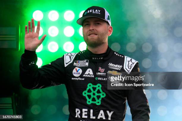 William Byron waves to the fans during driver introductions prior to the running of the NASCAR Cup Series Playoff Bass Pro Shops Night Race on...