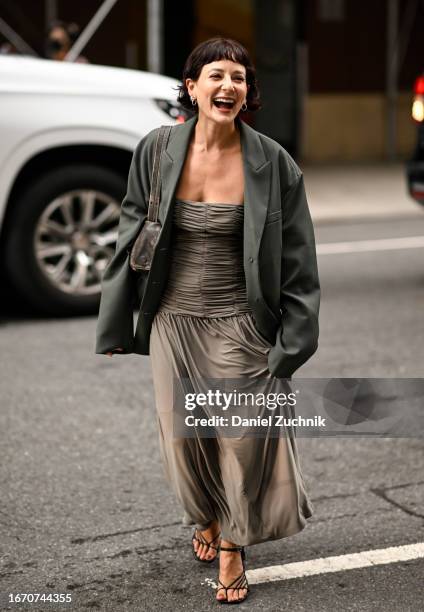 Alyssa Coscarelli is seen wearing a dark green over sized blazer and gray dress with black heels outside the Tibi show during NYFW S/S 2024 on...
