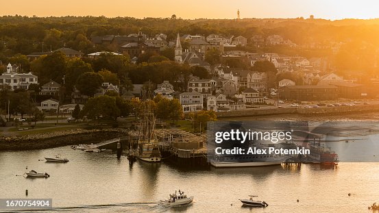 Evening view of Frazier State Pier in Plymouth Harbor, located in Cape Cod Bay, with the Plymouth town at the backdrop. Plymouth, Massachusetts, USA.