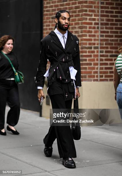 Guest is seen wearing a black cross jeweled jacket and black pants with a black bag outside the Tibi show during NYFW S/S 2024 on September 09, 2023...