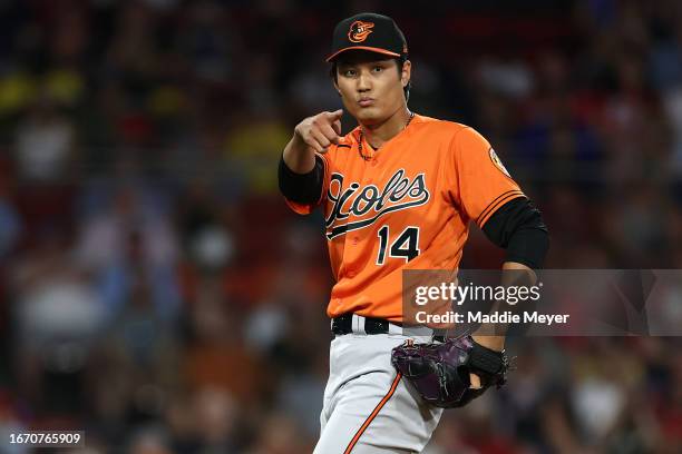 Shintaro Fujinami of the Baltimore Orioles points to first base during the sixth inning against the Boston Red Sox at Fenway Park on September 09,...