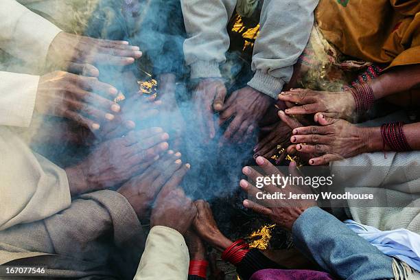 pilgrims warming their hands on a cool morning - prayagraj bildbanksfoton och bilder