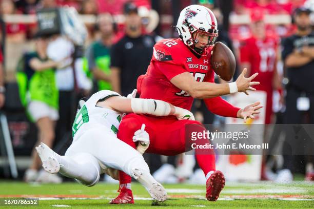 Quarterback Tyler Shough of the Texas Tech Red Raiders fumbles the ball while being tackled by Bryce Boettcher of the Oregon Ducks during the first...