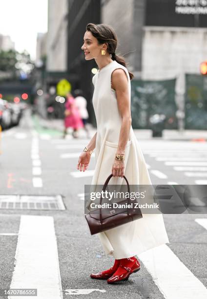 Mary Leest is seen wearing a white Tibi dress, brown bag and red gel Tibi shoes outside the Tibi show during NYFW S/S 2024 on September 09, 2023 in...