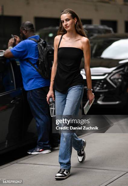 Model Alise Daugule is seen wearing a black sleeveless top, blue jeans and Nike sneakers outside the Tibi show during NYFW S/S 2024 on September 09,...
