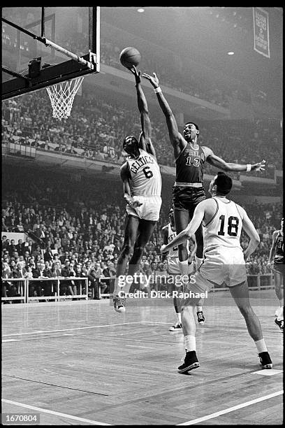 Wilt Chamberlain of the Philadelphia 76ers gets his shot blocked by Bill Russell of the Boston Celtics during the 1960 NBA game at the Boston Garden...