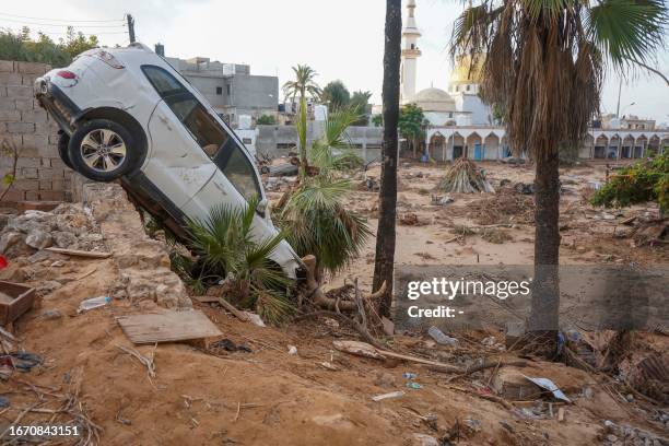 Vehicles are buried in mud and rubble in the aftermath of a devastating flood in eastern Libya's city of Derna, on September 16, 2023. A week after a...