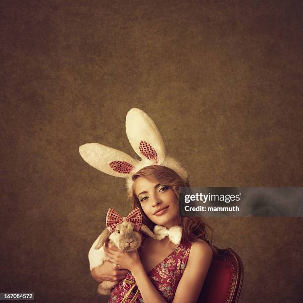 bunny girl holding a rabbit - bunny girl stockfoto's en -beelden