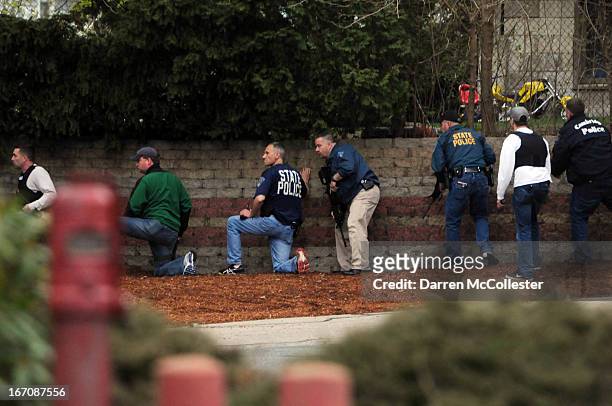 Law enforcement respond to shots at a scene reportedly where a suspect is hiding on April 19, 2013 in Watertown, Massachusetts. After a car chase and...