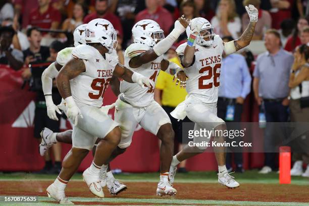 Jerrin Thompson of the Texas Longhorns celebrates with teammates after intercepting the ball during the fourth quarter against the Alabama Crimson...