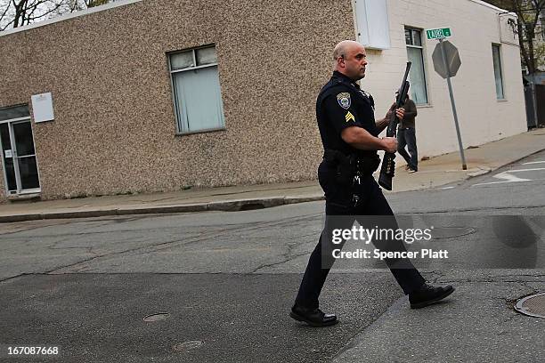 Police converge near the scene where it was believed 19-year-old bombing suspect Dzhokhar A. Tsarnaev is in hiding on April 19, 2013 in Watertown,...