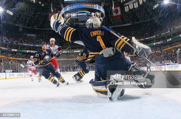 Jhonas Enroth of the Buffalo Sabres reaches to make a glove save in front of teammate Adam Pardy and Taylor Pyatt of the New York Rangers on April...