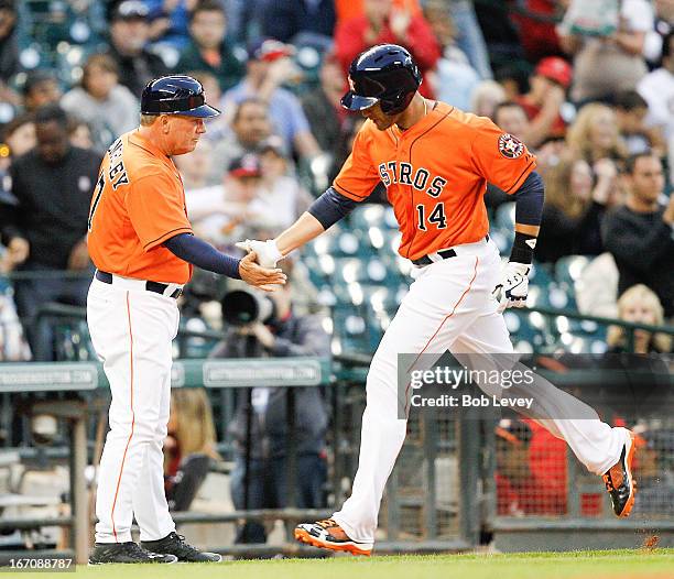 Justin Maxwell of the Houston Astros receives congratulations from third base coach Dave Trembley after hitting a home run in the second inning...