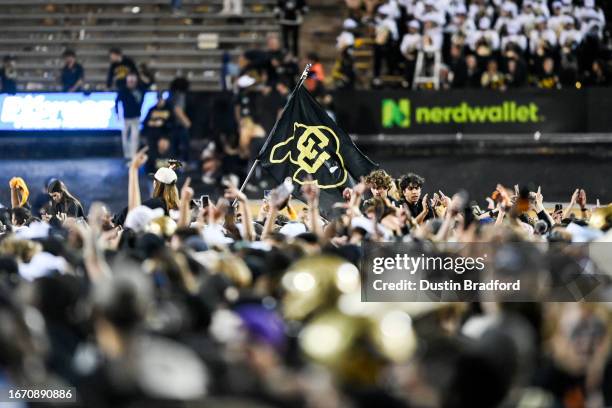 Spectators rush the field after a double overtime win for the Colorado Buffaloes against the Colorado State Rams at Folsom Field on September 16,...