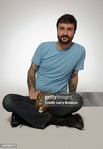 Mike Bridavsky poses with Lil Bub of the film "Lil Bub & Friendz" at the Tribeca Film Festival 2013 portrait studio on April 19, 2013 in New York...