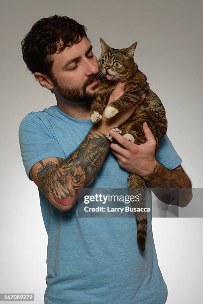 Mike Bridavsky poses with Lil Bub of the film "Lil Bub & Friendz" at the Tribeca Film Festival 2013 portrait studio on April 19, 2013 in New York...