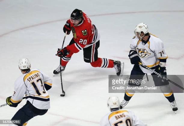 Brandon Saad of the Chicago Blackhawks shoots and scores a goal surrounded by Nick Spaling, Daniel Bang and Sergei Kostitsyn of the Nashville...