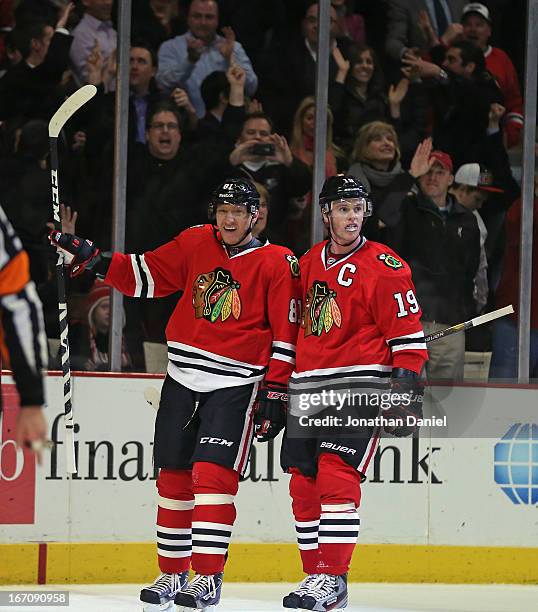 Marain Hossa and Jonathan Toews of the Chicago Blackhawks celebrate Hossa's winning goal in overtime against the Nashville Predators at the United...