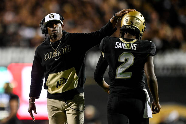 Head coach Deion Sanders of the Colorado Buffaloes celebrates with quarterback Shedeur Sanders after a fourth quarter touchdown against the Colorado...
