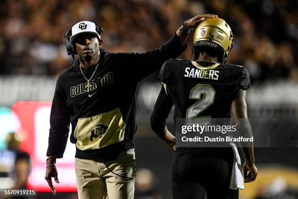 Head coach Deion Sanders of the Colorado Buffaloes celebrates with quarterback Shedeur Sanders after a fourth quarter touchdown against the Colorado...