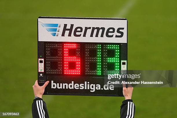 The 4th official referee holds the referee board with substitution numbers during the Second Bundesligamatch between Jahn Regensburg and FC...