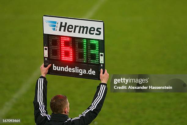 The 4th official referee holds the referee board with substitution numbers during the Second Bundesligamatch between Jahn Regensburg and FC...