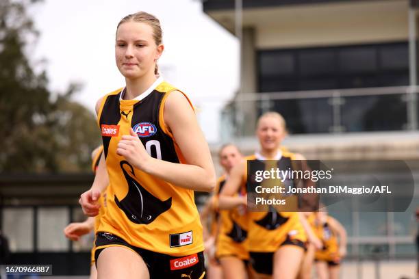 Molly Reimers of the Stingrays runs out onto the field during the Coates Talent League Girls Quarter Final match between Dandenong Stingrays and GWV...