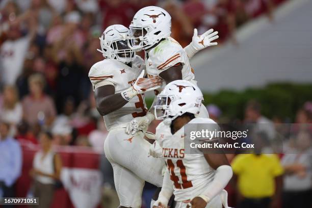 Anthony Hill Jr. #0 of the Texas Longhorns celebrates with teammates after sacking Jalen Milroe of the Alabama Crimson Tide during the fourth quarter...