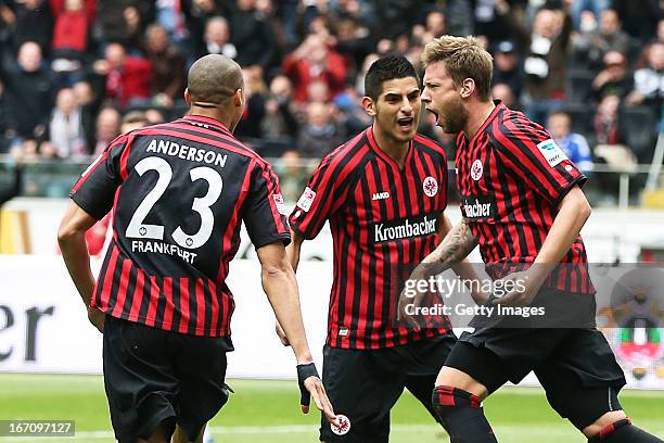 Marco Russ celebrates after scoring his team's first goal with Anderson and Carlos Zambrano of Frankfurt during the Bundesliga match between...