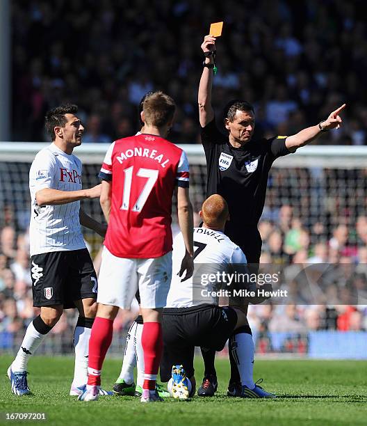 Referee Andre Marriner shows Steve Sidwell of Fulham a red card and sents him off after a tackle on Mikel Arteta of Arsenal during the Barclays...