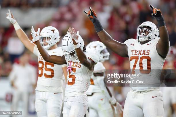 Adonai Mitchell of the Texas Longhorns celebrates with teammates after defeating the Alabama Crimson Tide 34-24 at Bryant-Denny Stadium on September...
