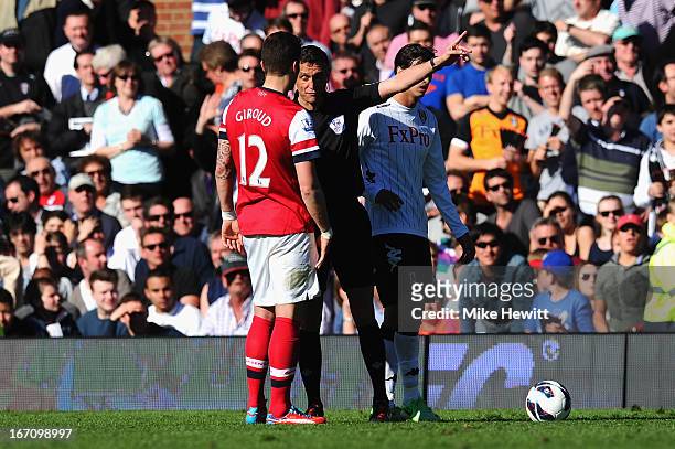 Olivier Giroud of Arsenal is sent off by referee Andre Marriner after a tackle on Stanislav Manolev of Fulham during the Barclays Premier League...