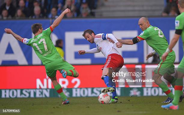 Rafael Van Der Vaart of Hamburg is challenged by Andreas Lambertz and Dani Schahin of Duesseldorf during the Bundesliga match between Hamburger SV...