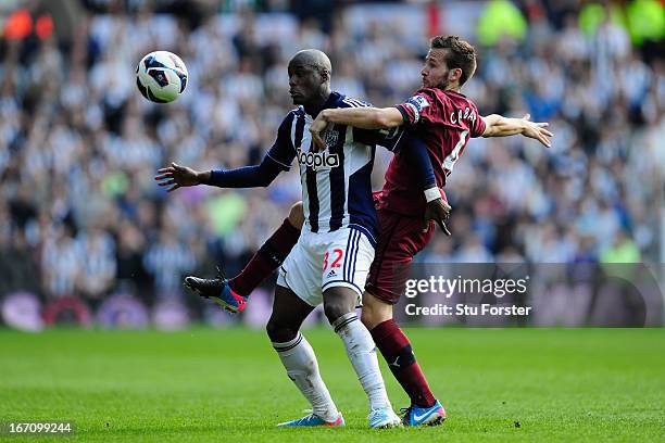 Newcastle player Yohan Cabaye challenges WBA player Marc-Antoine Fortune during the Barclays Premier League match between West Bromwich Albion and...