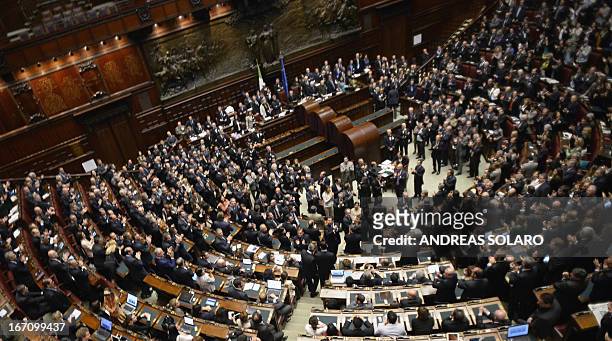 Italian Deputies and Senators applaud in the Italian Parliament in Rome on April 20, 2013 after Italian President Giorgio Napolitano was confirmed...