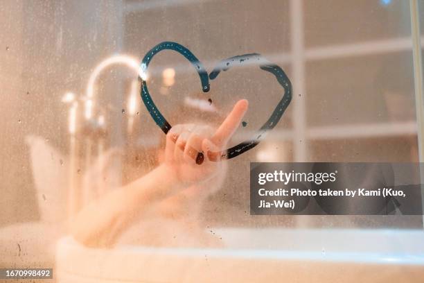 blurry bathroom woman draws a heart - domestic bathroom stock pictures, royalty-free photos & images