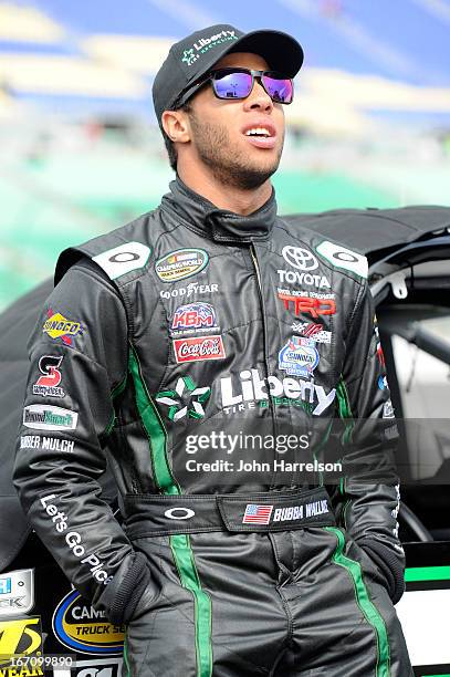 Darrell Wallace Jr., driver of the LibertyTireRecycling/Ground SmartRubber Toyota, walks in the grid during qualifying for the NASCAR Camping World...