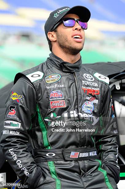 Darrell Wallace Jr., driver of the LibertyTireRecycling/Ground SmartRubber Toyota, walks in the grid during qualifying for the NASCAR Camping World...