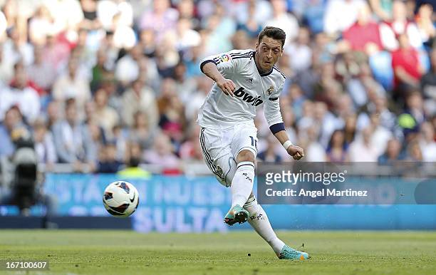 Mesut Ozil of Real Madrid shoots to score the opening goal during the La Liga match between Real Madrid and Real Betis Balompie at Estadio Santiago...