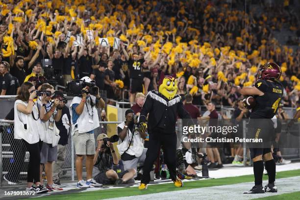 Running back Cameron Skattebo of the Arizona State Sun Devils celebrates after scoring on a 13-yard rushing touchdown against the Oklahoma State...