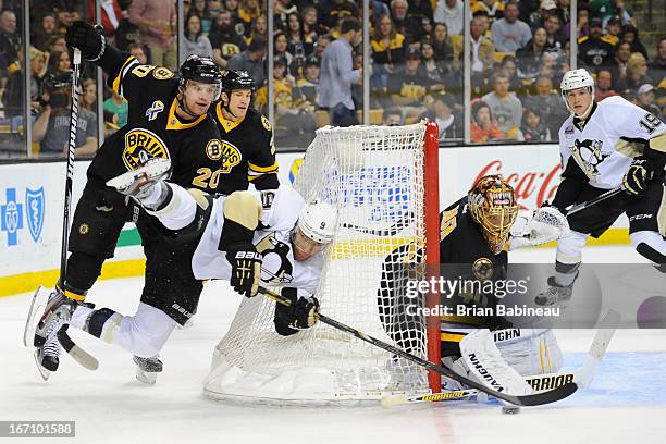 Pascal Dupuis of the Pittsburgh Penguins handles the puck against Daniel Paille and Tuukka Rask of the Boston Bruins at the TD Garden on April 20,...