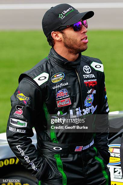 Darrell Wallace Jr., driver of the LibertyTireRecycling/Ground SmartRubber Toyota, stands on the grid during qualifying for the NASCAR Camping World...