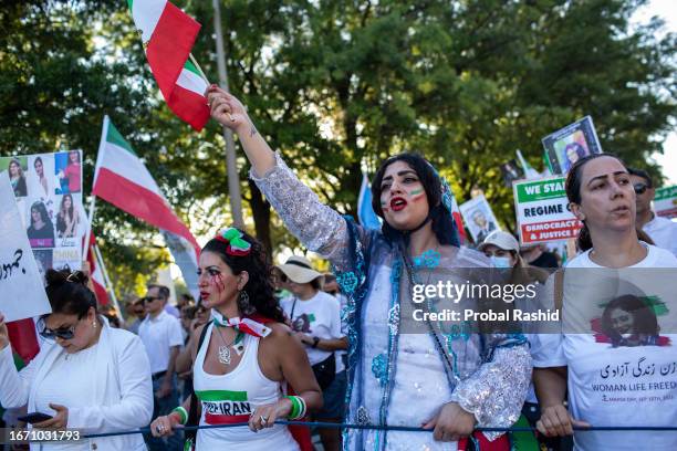 Demonstrator raises her fist while attending in a demonstration to mark the Mahsa Amini's first death anniversary in Washington DC. Mahsa Amini, a...