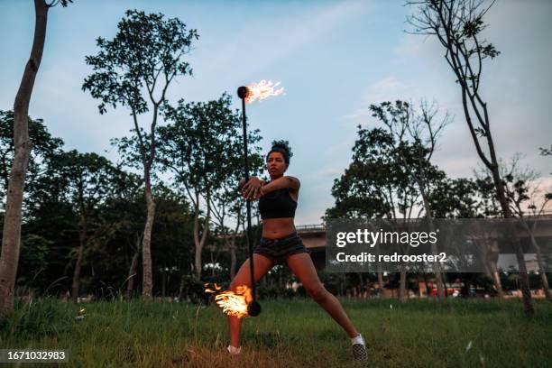 fire dancers at an urban park - fire dancer stock pictures, royalty-free photos & images