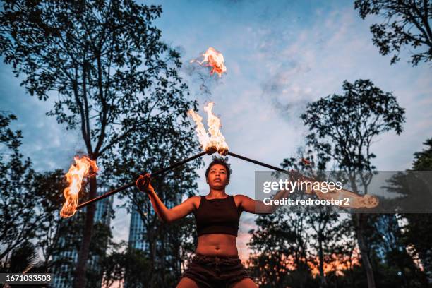 fire dancers at an urban park - fire dancer stock pictures, royalty-free photos & images